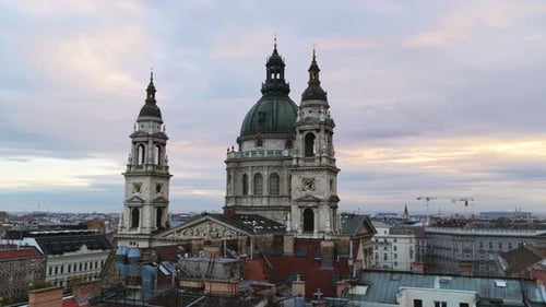 A closer aerial of St. Stephen’s Basilica’s towers and dome glowing in the pastel evening light.