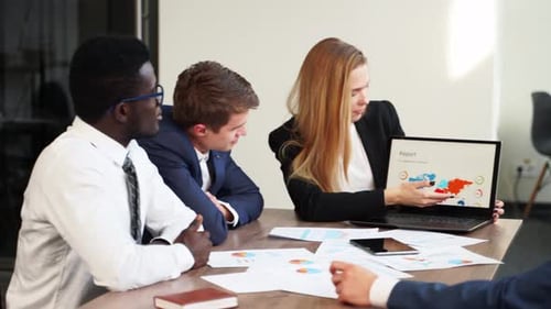 Team Discussing Report at Conference Table