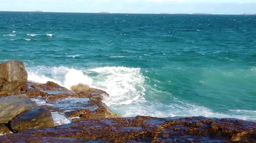 Waves Crashing Against Rocky Shoreline