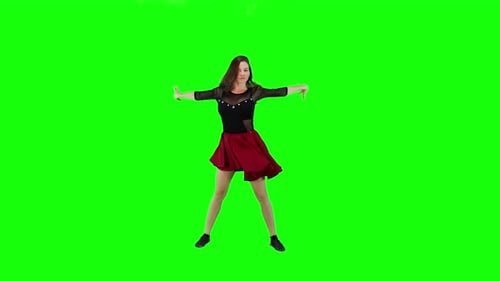 Young woman dancing on a green screen background