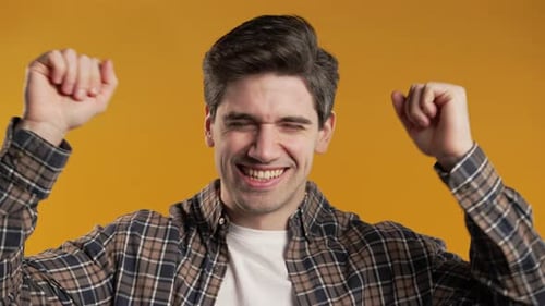 Man Dancing Joyfully on Orange Background