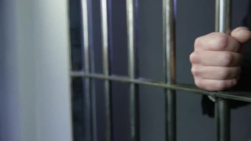 Crime en col blanc : un homme d'affaires met la main sur les barreaux de prison HD