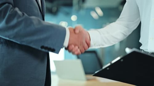 Businessmen Reaching Out for a Handshake in a Modern Office Slow Motion