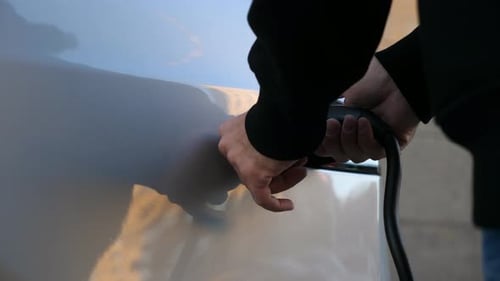 Removing Charger From Electric Vehicle at Charging Port