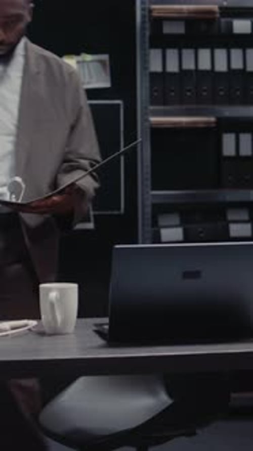 Vertical Video Young Policeman Examining Forensic Evidence in Office