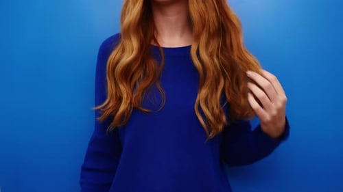 Woman Plays with Long Auburn Wavy Hair