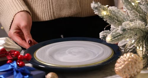 Festive Table Setting with Evergreen and Holiday Decorations