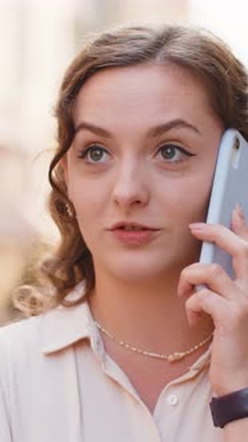Happy Young Woman Having Remote Conversation Talking on Smartphone Good News Gossip in City Street