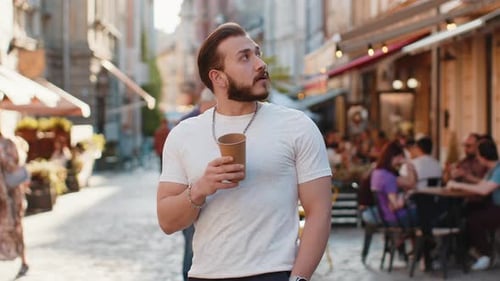 Young Man Guy Enjoying Drinking Morning Coffee Hot Drink Relaxing Taking a Break in City Street