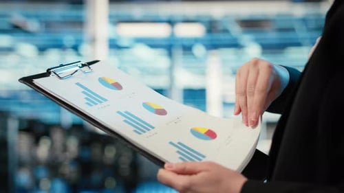 Data Center Admin Verifying Infrastructure Status with Clipboard Files Closeup