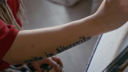 Woman sketching on canvas in studio