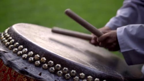 Energetic Outdoor Drumming Performance with Vibrant Rhythmic Beats