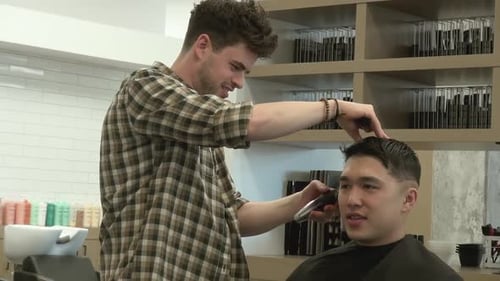 Man Getting Haircut at Barbershop by Stylish Barber