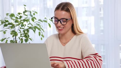 Young Woman Video Conferencing with Laptop Computer