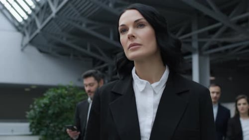 Successful businesswoman walking confidently at corporate finance summit meeting