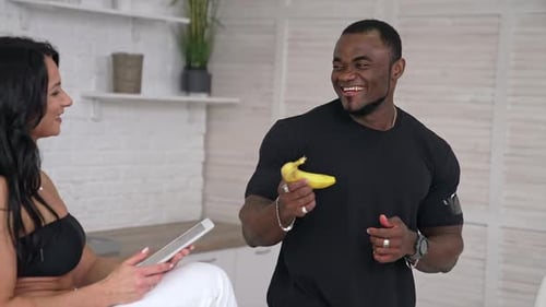 Healthy strong couple cooking vegeterian food.