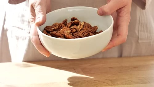 Bowl of Fresh Pecans in Person's Hands