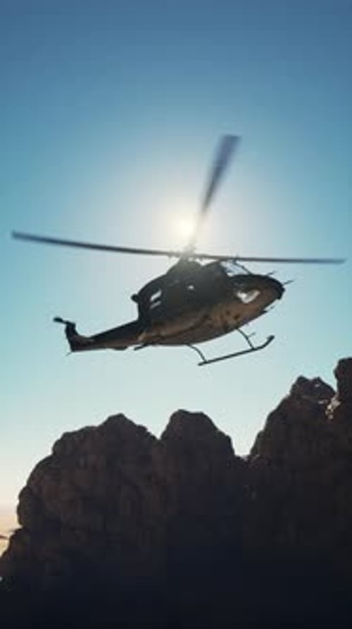 Helicopter Over Rocky Mountain Range