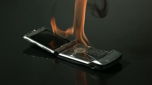 Burning Phone Being Smashed with Hammer on Dark