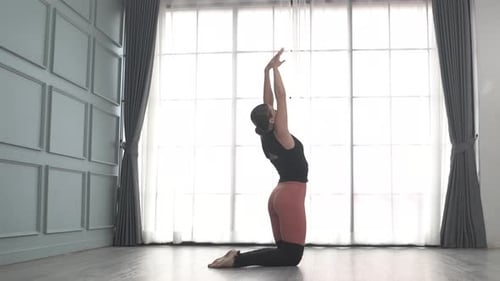 Friends practice ballet dance at studio.