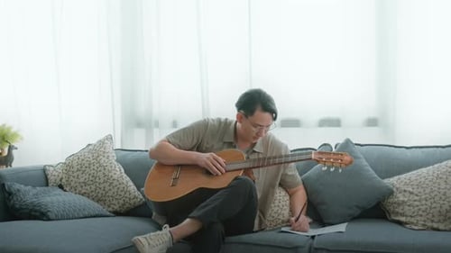 A musician is writing song in home Studio