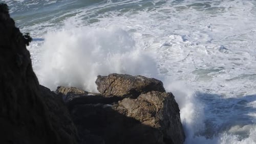 Big wave hit rocky shore in slow motion