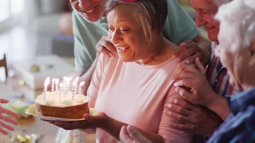 Seniors Celebrating Birthday with Cake and Friends