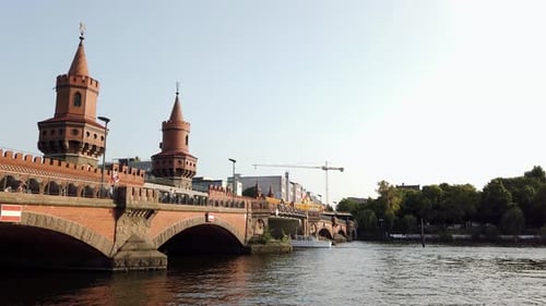 Boats on Spree River and Undergrund Train on Oberbaum Bridge in Berlin