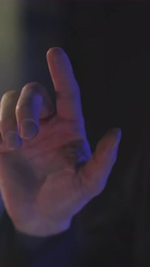 A CloseUp of Hands in Soft Focus Under Dim Lighting Enhancing the Ambiance and Emotion