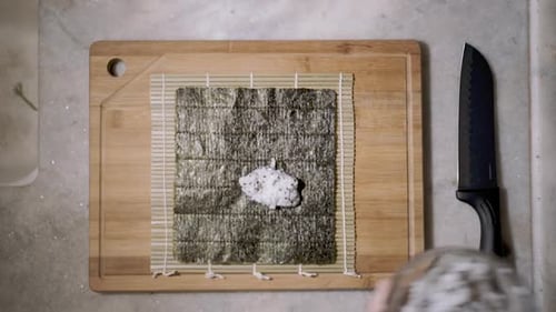 Making Sushi with Rice, Nori, and Bamboo Mat