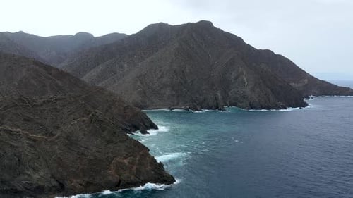Aerial view of rocky cliffs in the coastline of the volcanic island of La Gomera, Spain.