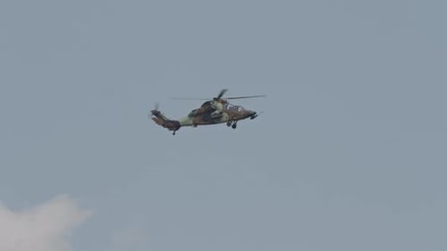 Military Helicopter Flying Under Blue Sky