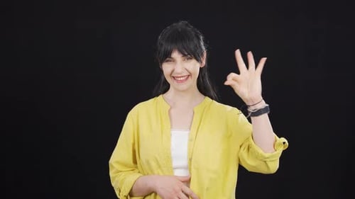 Smiling Woman Giving Positive Hand Gestures