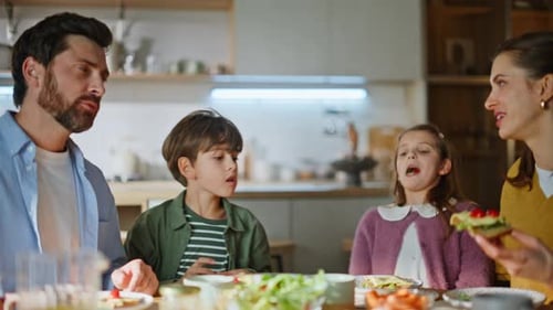 Happy family eating healthy lunch at home