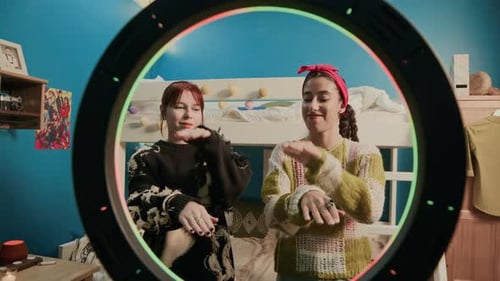 Two Young Women Dancing in Bedroom with Ring Light