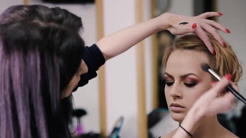 Makeup Artist Applying Makeup in Beauty Studio