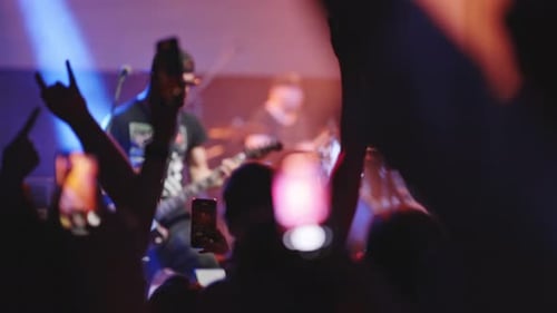 People Have Fun at a Rock Concert in a Nightclub