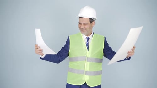 Man in Hard Hat Looking at Blueprints