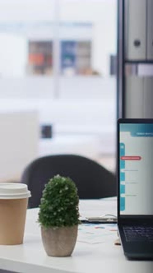 Vertical Video Laptop Device on Office Desk in Empty Workspace Showing Volatile Stock Exchange