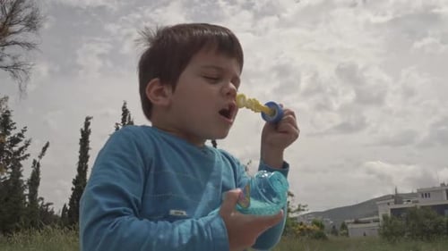 Kid Plays with a bubble blowing toy 60fps