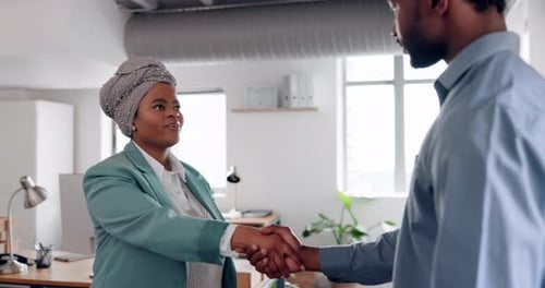 Handshake, meeting and partnership with a man and black woman shaking hands for a business deal