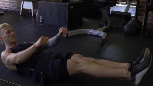 Muskulöser Mann im Heim-Fitnessstudio beim Bauchmuskeltraining