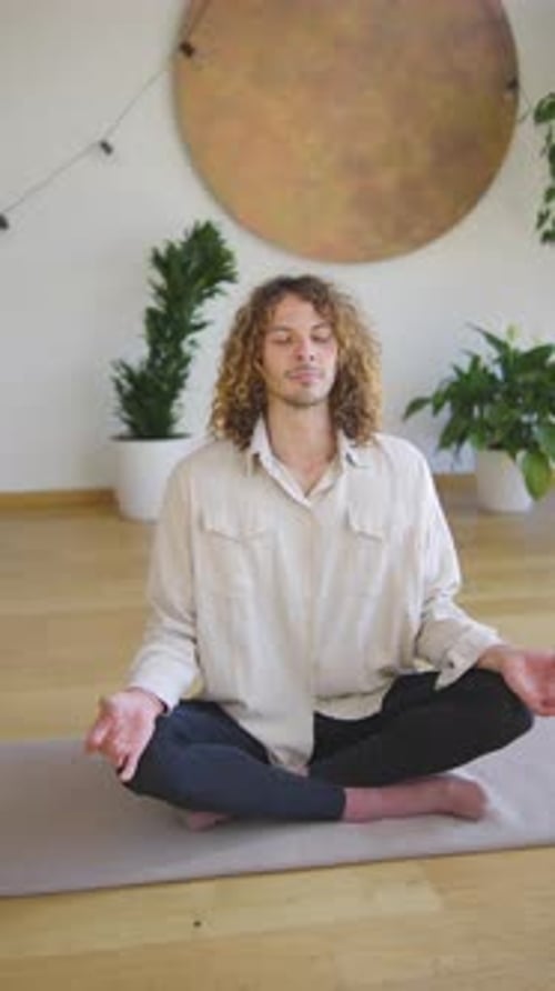 Man Meditating Calmly Indoors on Yoga Mat