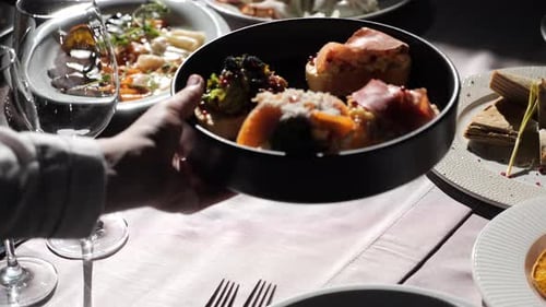 A Waiter Puts Bruschetta on the Table in an Elite Italian Restaurant