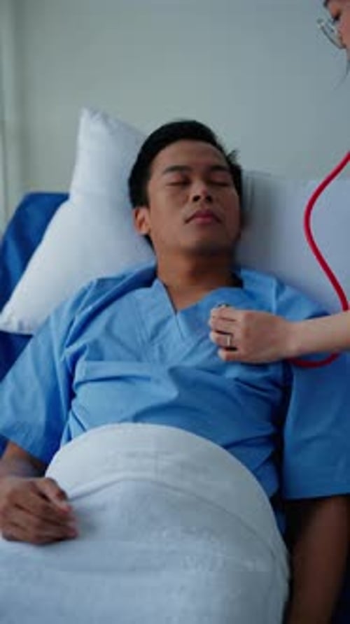 Vertical footage of Doctor examining patient in hospital.