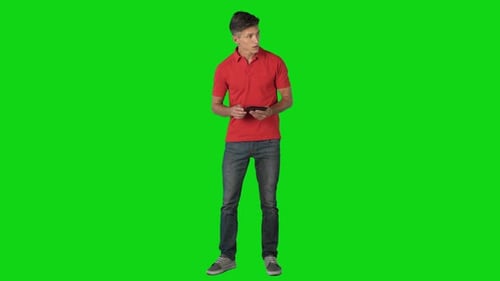 Young Adult Using Tablet on Green Screen