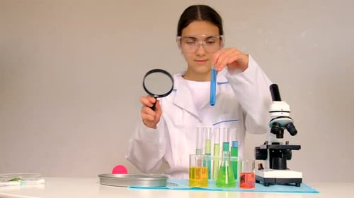 Young Scientist With Colorful Beakers and Microscope