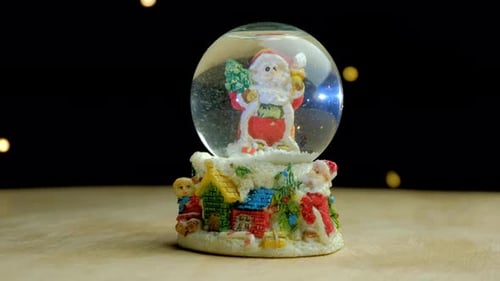 Christmas Snow Globe with Snow Falling Around Santa Claus