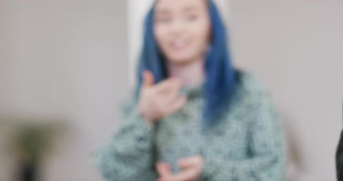 Happy diverse male and female dancers discussing in dance studio, slow motion