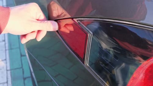 Plugging in a charger to an electric car